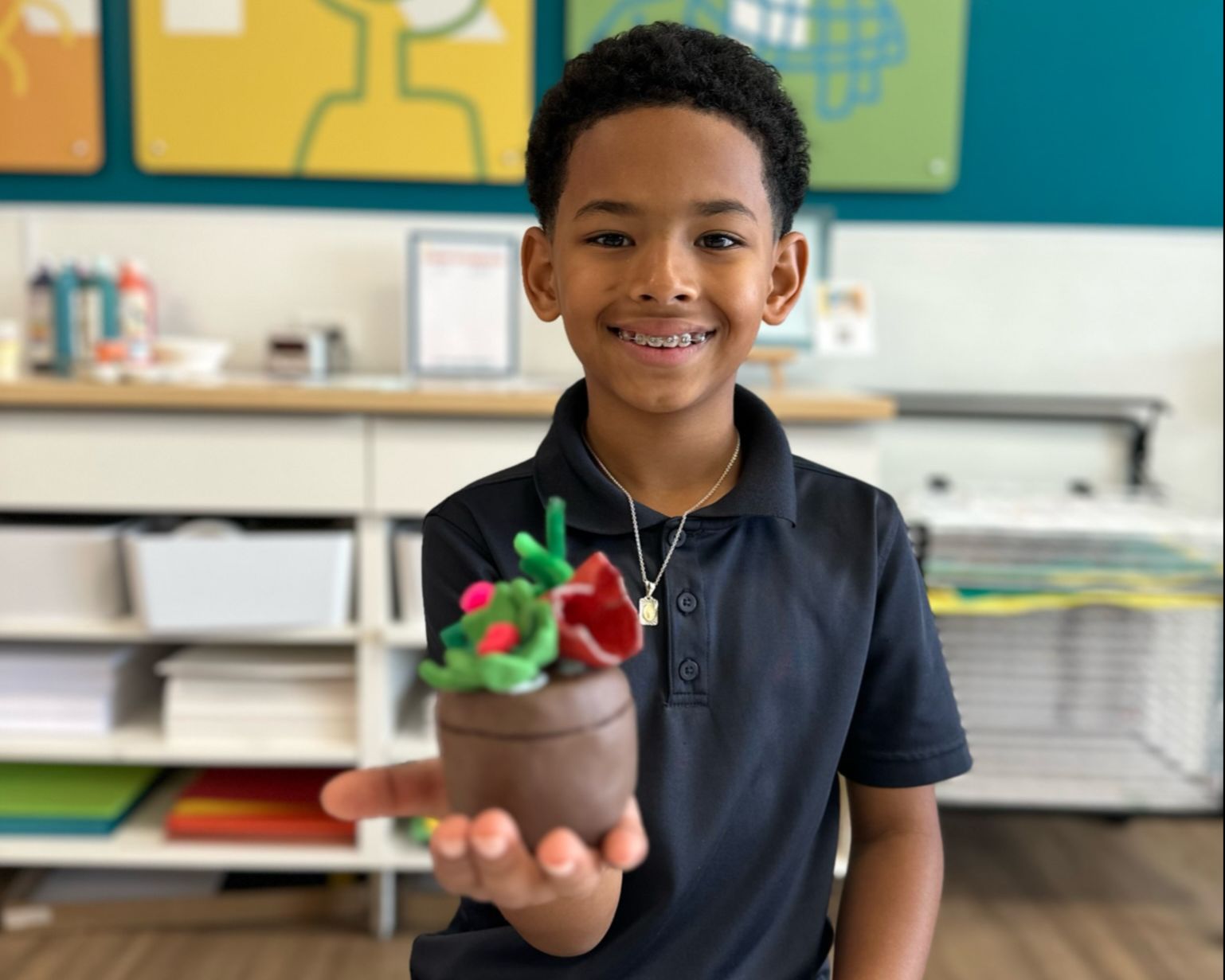 BOY SMILING WITH CLAY ART